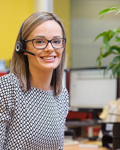 Customer Care team member wearing telephone headset