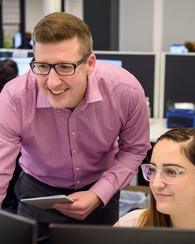 Salary packaging Relationship Team members looking at a computer screen