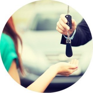 A woman being passed the keys to her new car