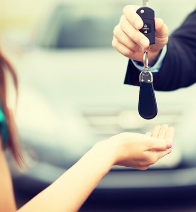 Woman accepting keys for a car