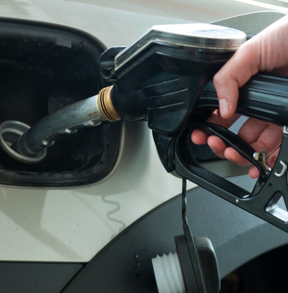 Close up of a person filling their car with fuel