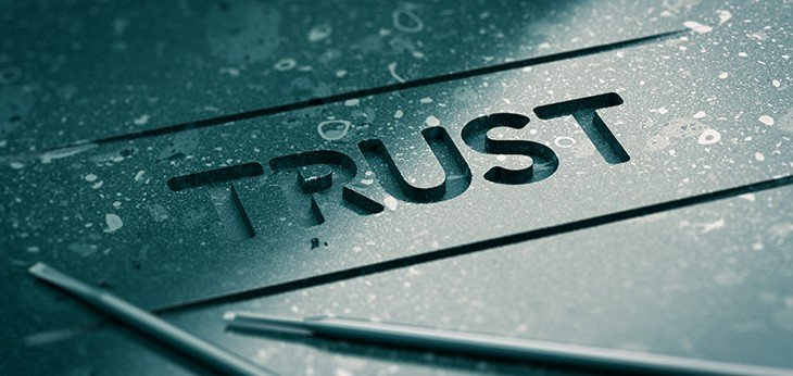 The word trust engraved into a piece of metal