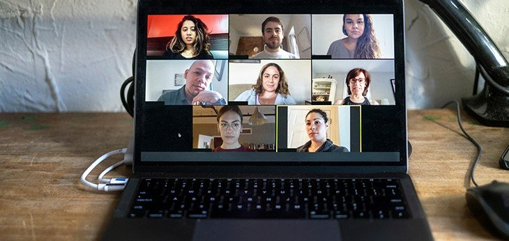 a laptop showing multiple meeting on screen holding a meeting