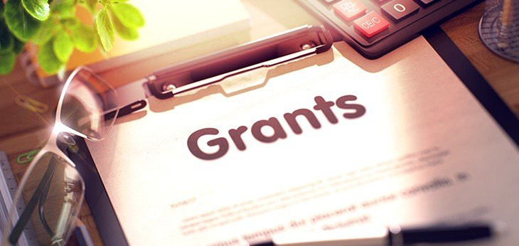 grants written on clipboard